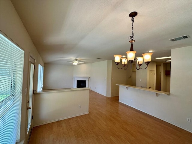 4526 Tello Path, Austin, TX 78749 - unfurnished room with a ceiling fan, light wood-style floors, a chandelier, a fireplace, and baseboards