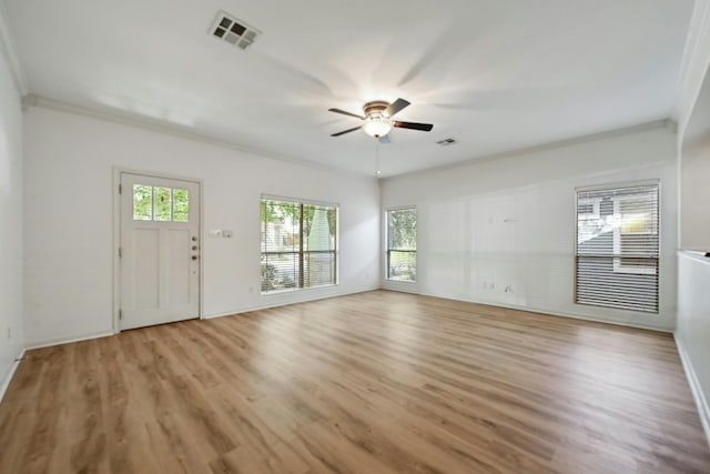 2408 Amur Dr, Austin, TX 78745 - unfurnished living room with light wood-style floors, ceiling fan, ornamental molding, and baseboards