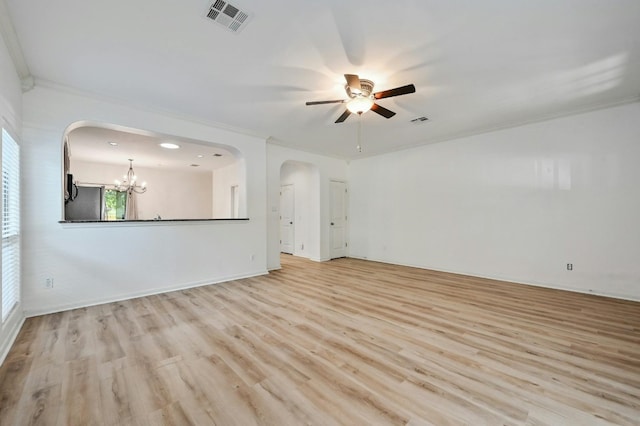 2408 Amur Dr, Austin, TX 78745 - unfurnished living room featuring crown molding, a ceiling fan, light wood-type flooring, arched walkways, and a chandelier