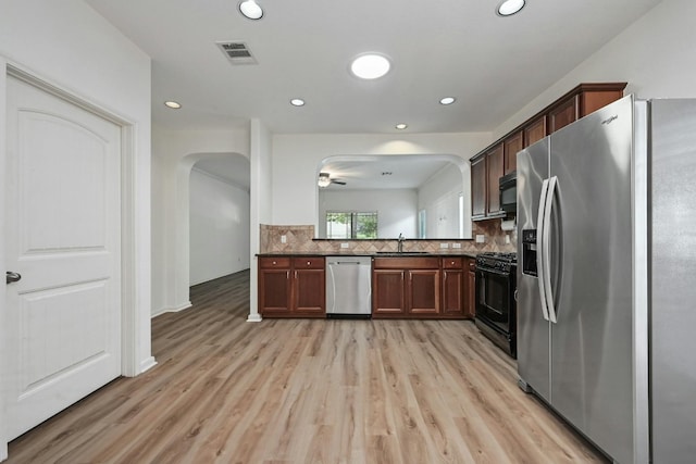 2408 Amur Dr, Austin, TX 78745 - kitchen featuring black appliances, dark countertops, light wood-type flooring, backsplash, and recessed lighting