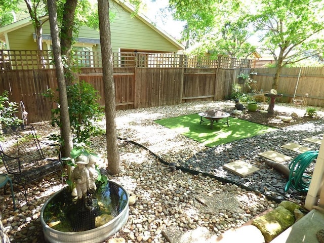 2408 Amur Dr, Austin, TX 78745 - fenced backyard with a fire pit