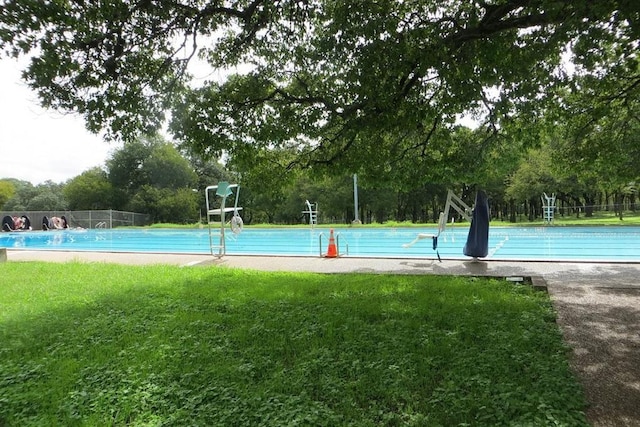 2408 Amur Dr, Austin, TX 78745 - view of sport court featuring a lawn and view of wooded area