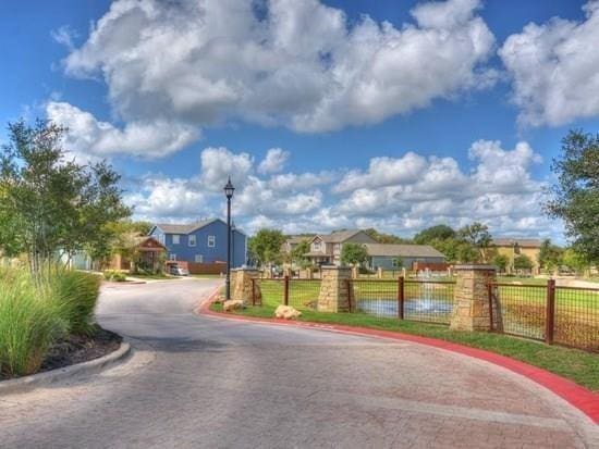 2408 Amur Dr, Austin, TX 78745 - view of asphalt street with street lights, curbs, and a residential view