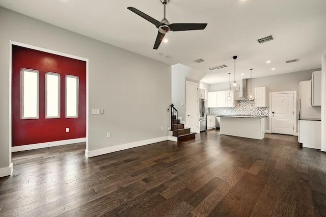 2305 E 16th St Unit A, Austin, TX 78702 - unfurnished living room with a ceiling fan, dark wood finished floors, baseboards, recessed lighting, and stairway