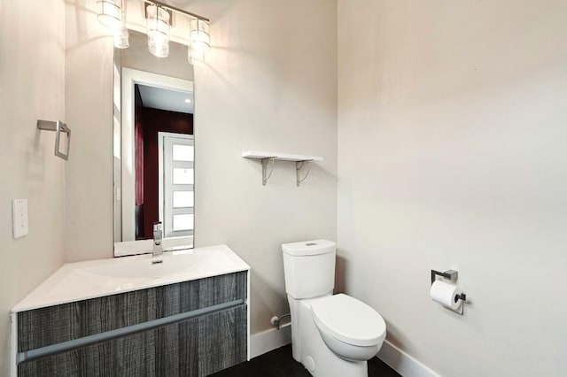 2305 E 16th St Unit A, Austin, TX 78702 - half bathroom featuring toilet, vanity, and baseboards