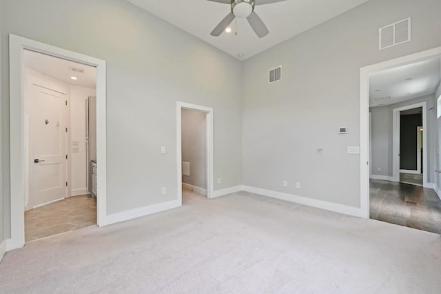 2305 E 16th St Unit A, Austin, TX 78702 - unfurnished bedroom with carpet floors, baseboards, a towering ceiling, ensuite bath, and recessed lighting