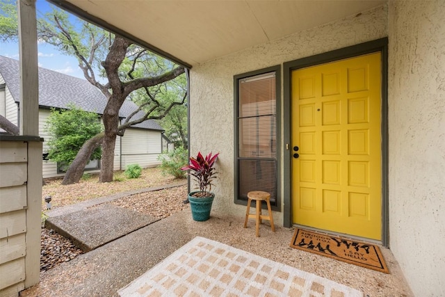 doorway to property with stucco siding