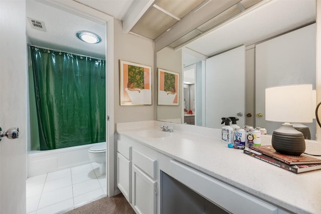 bathroom featuring toilet, vanity, shower / bath combo with shower curtain, and tile patterned floors