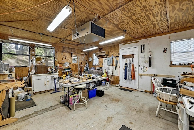 11519 Shakespearean Way, Austin, TX 78759 - miscellaneous room with a workshop area, concrete floors, a heating unit, and wood walls