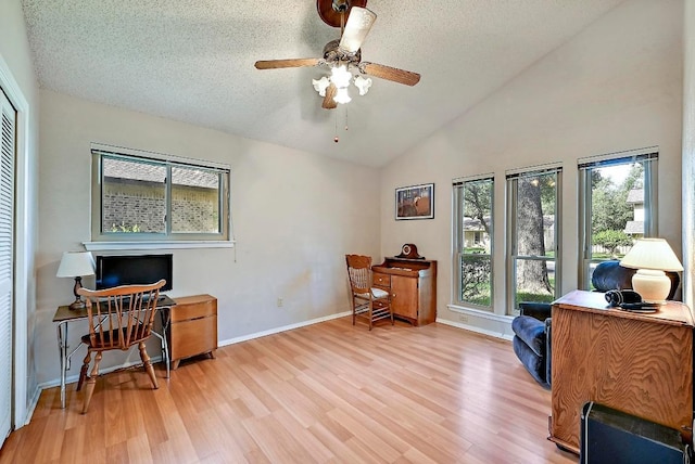 11519 Shakespearean Way, Austin, TX 78759 - office area featuring wood finished floors, ceiling fan, a textured ceiling, baseboards, and high vaulted ceiling