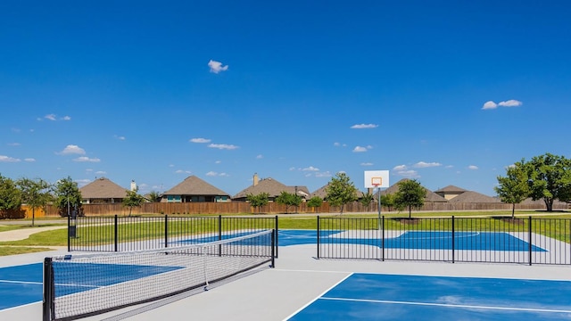view of basketball court with fence, a tennis court, and community basketball court