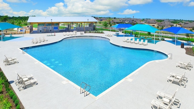 community pool featuring a patio area and fence