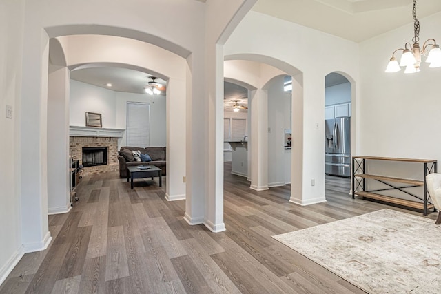 6419 Ira Ingram Dr, Austin, TX 78749 - foyer entrance featuring a ceiling fan, wood finished floors, a fireplace, and a chandelier