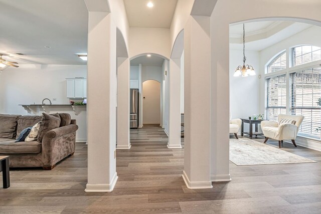6419 Ira Ingram Dr, Austin, TX 78749 - entryway with arched walkways, wood finished floors, ceiling fan, recessed lighting, and a chandelier