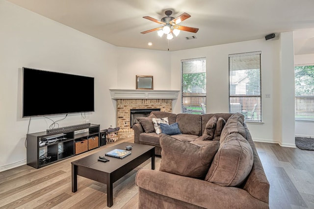 6419 Ira Ingram Dr, Austin, TX 78749 - living area featuring wood finished floors, ceiling fan, and a brick fireplace