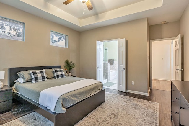 6419 Ira Ingram Dr, Austin, TX 78749 - bedroom with a raised ceiling, dark wood-type flooring, ensuite bathroom, and ceiling fan