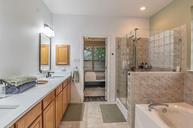 6419 Ira Ingram Dr, Austin, TX 78749 - ensuite bathroom featuring a shower stall, double vanity, a bath, tile patterned flooring, and recessed lighting