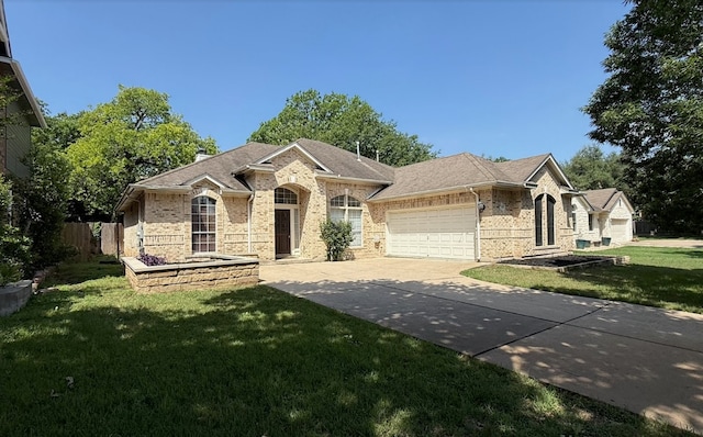 6419 Ira Ingram Dr, Austin, TX 78749 - view of front of home featuring an attached garage, brick siding, driveway, and a shingled roof