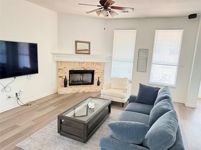 6419 Ira Ingram Dr, Austin, TX 78749 - living room featuring ceiling fan, wood finished floors, and a fireplace