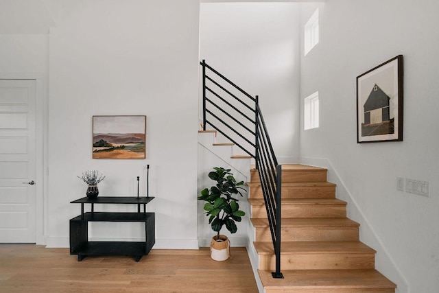 6116 Toscana Ave, Austin, TX 78724 - staircase with healthy amount of natural light, wood finished floors, and baseboards