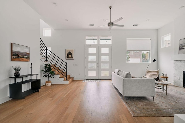 6116 Toscana Ave, Austin, TX 78724 - living area featuring french doors, stairway, and plenty of natural light