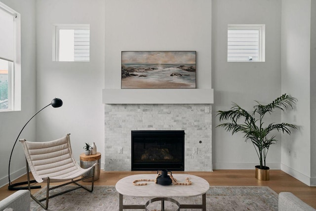 6116 Toscana Ave, Austin, TX 78724 - living area with wood finished floors, a glass covered fireplace, and baseboards