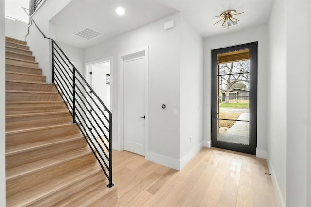 1719 Piedmont Ave, Austin, TX 78757 - foyer with stairs, light wood finished floors, baseboards, and recessed lighting