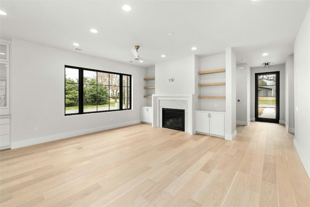 1719 Piedmont Ave, Austin, TX 78757 - unfurnished living room featuring plenty of natural light, a premium fireplace, recessed lighting, light wood-type flooring, and ceiling fan