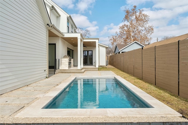 1719 Piedmont Ave, Austin, TX 78757 - view of swimming pool featuring ceiling fan, a patio, and a fenced backyard