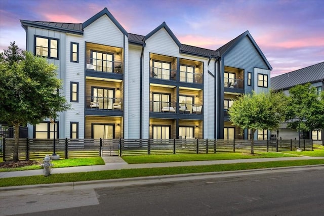 3101 Govalle Ave Unit 114, Austin, TX 78702 - view of property with a standing seam roof, metal roof, and a fenced front yard
