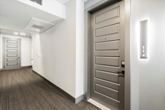 3101 Govalle Ave Unit 114, Austin, TX 78702 - corridor featuring dark carpet and baseboards