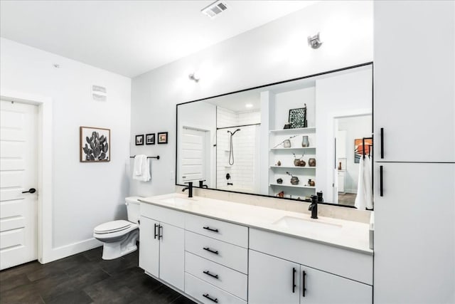 3101 Govalle Ave Unit 114, Austin, TX 78702 - bathroom featuring a shower stall, toilet, double vanity, and baseboards