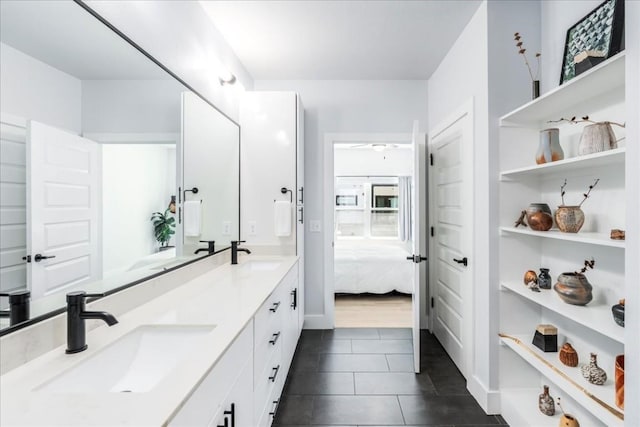 3101 Govalle Ave Unit 114, Austin, TX 78702 - full bathroom featuring connected bathroom, tile patterned floors, double vanity, ceiling fan, and built in shelves