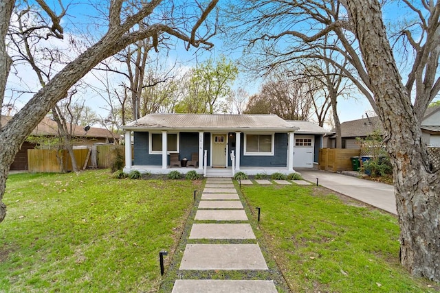 5614 Shoalwood Ave, Austin, TX 78756 - view of front of house featuring a porch, driveway, a garage, and metal roof