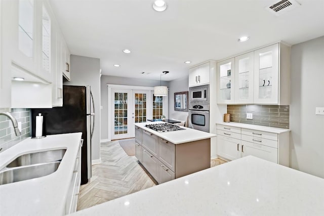 5614 Shoalwood Ave, Austin, TX 78756 - kitchen featuring appliances with stainless steel finishes, a sink, french doors, white cabinetry, and recessed lighting