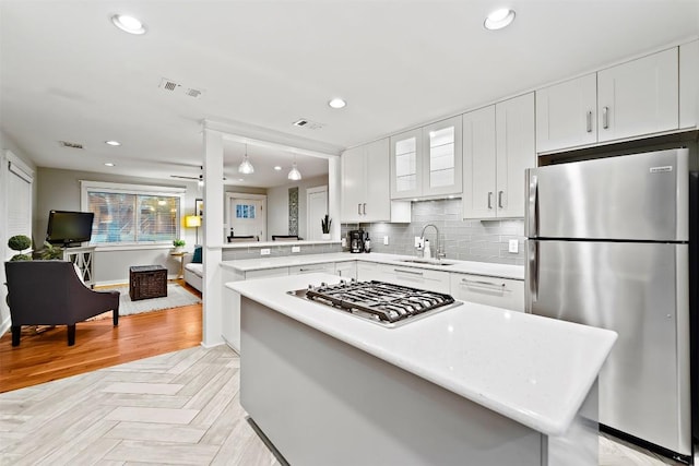5614 Shoalwood Ave, Austin, TX 78756 - kitchen with appliances with stainless steel finishes, light countertops, a sink, white cabinetry, and recessed lighting