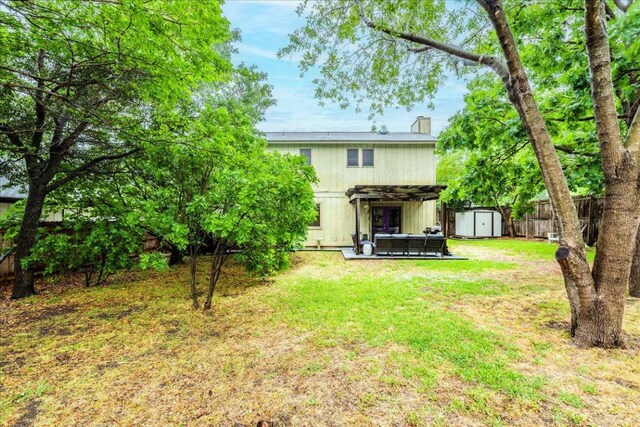 12005 Thompkins Dr, Austin, TX 78753 - back of property featuring a storage shed, a fenced backyard, and a chimney