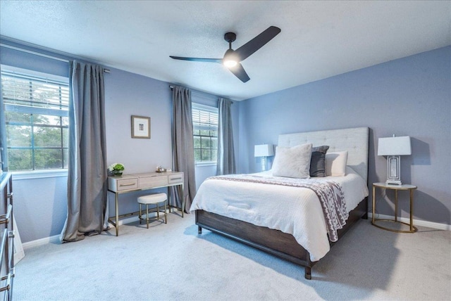 12005 Thompkins Dr, Austin, TX 78753 - carpeted bedroom with baseboards and a ceiling fan