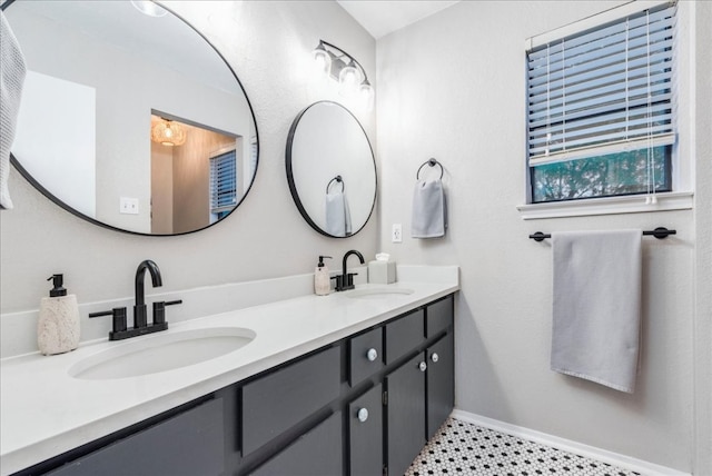 12005 Thompkins Dr, Austin, TX 78753 - full bathroom featuring double vanity and baseboards