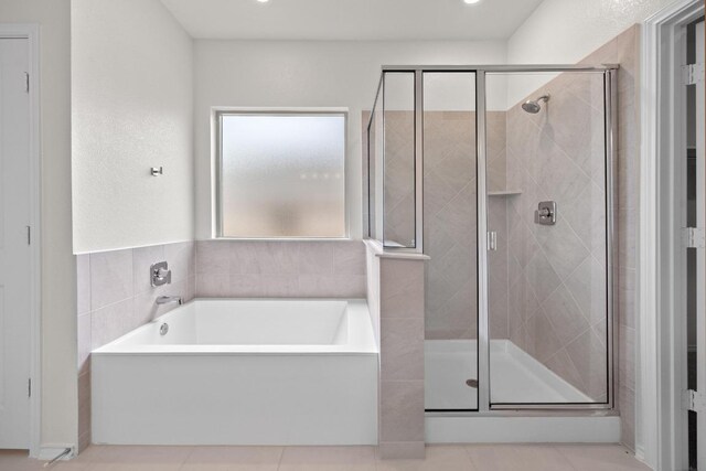3747 Liberi Ln, Round Rock, TX 78665 - bathroom featuring a bath, a stall shower, and tile patterned floors