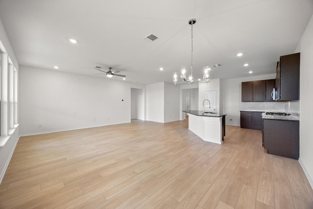 3747 Liberi Ln, Round Rock, TX 78665 - kitchen featuring a ceiling fan, a chandelier, recessed lighting, dark countertops, and open floor plan