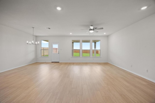 3747 Liberi Ln, Round Rock, TX 78665 - unfurnished living room featuring a ceiling fan, light wood-type flooring, a chandelier, and recessed lighting