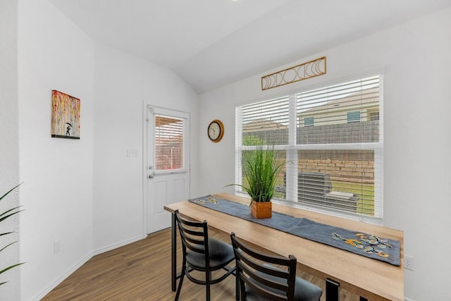 3201 Dusted Daisey St, Pflugerville, TX 78660 - dining room with vaulted ceiling, wood finished floors, and baseboards