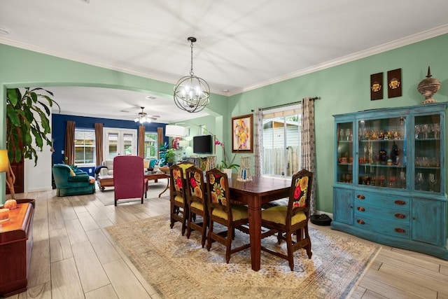 1907 Winsted Ln Unit 1, Austin, TX 78703 - dining space with healthy amount of natural light, a chandelier, arched walkways, ceiling fan, and crown molding