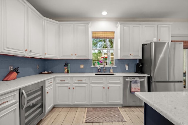 1907 Winsted Ln Unit 1, Austin, TX 78703 - kitchen with beverage cooler, stainless steel appliances, a sink, white cabinets, and backsplash