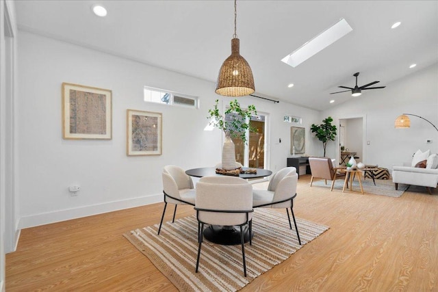 dining area featuring light wood-style floors, recessed lighting, a skylight, vaulted ceiling, and a ceiling fan