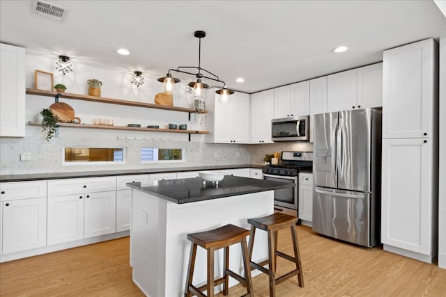 kitchen with stainless steel appliances, open shelves, white cabinetry, backsplash, and recessed lighting