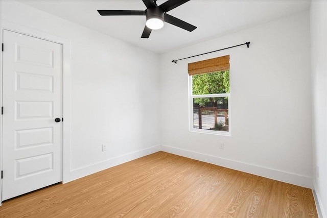 empty room with baseboards, light wood-style flooring, and ceiling fan