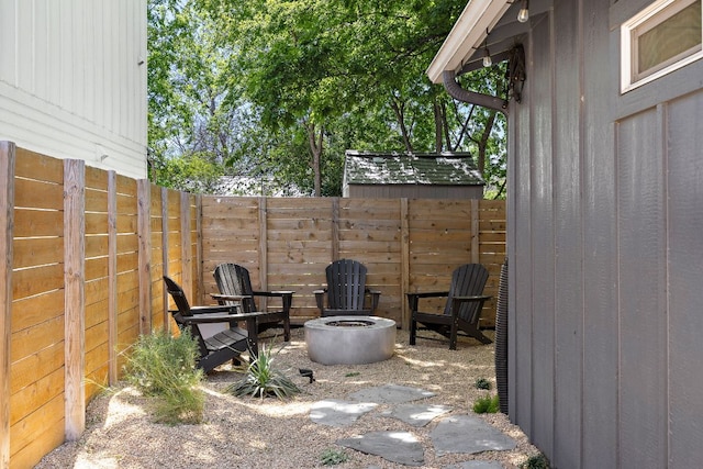 view of patio featuring a fenced backyard and a fire pit