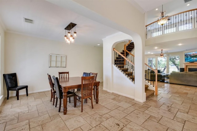 dining room with stone tile flooring, stairs, ceiling fan, recessed lighting, and ornamental molding